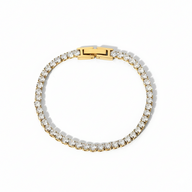 Gold bracelet with clear gemstones on a white background
