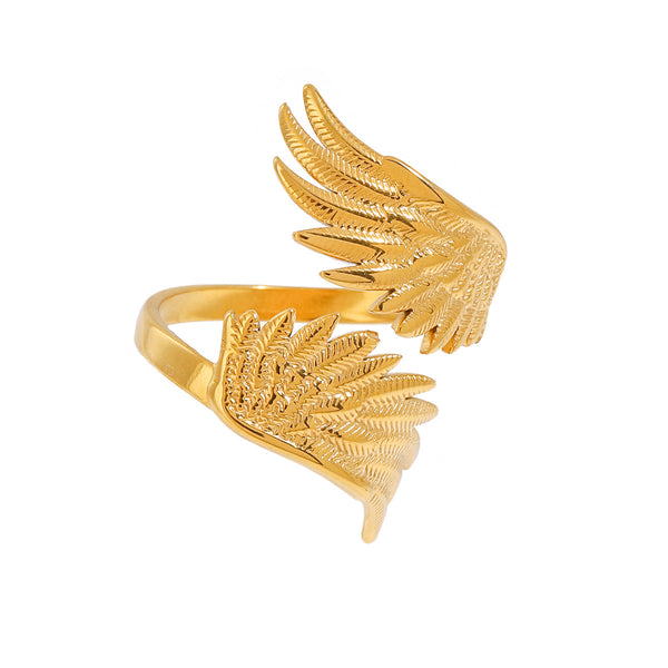 Gold wing-shaped ring on a white background