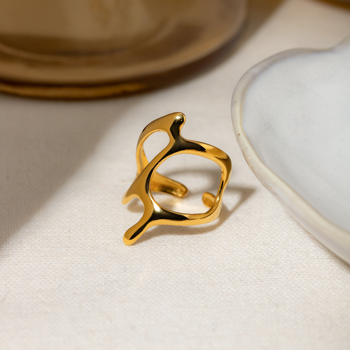 Gold ring on a light fabric surface with a blurred background